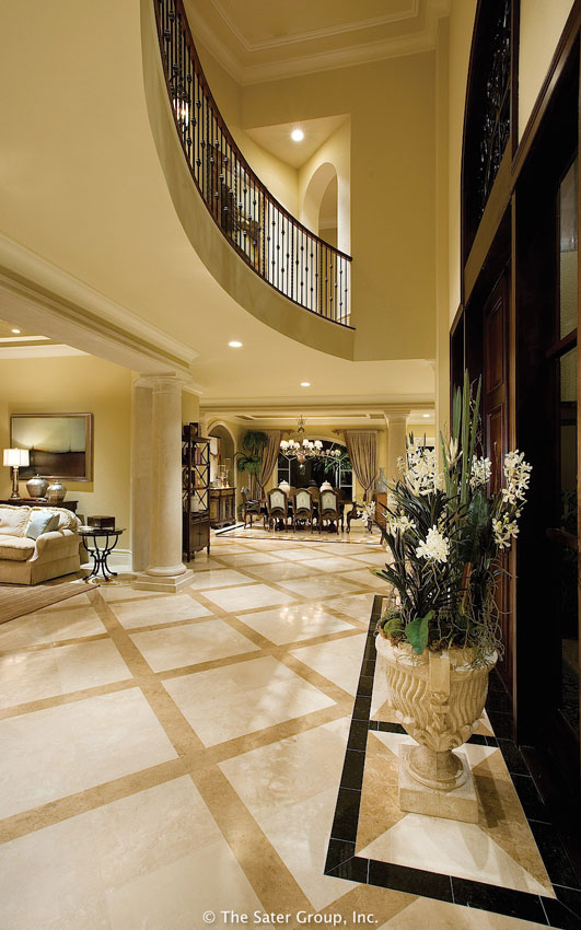 The foyer reveals the open floor plan and the balcony above.