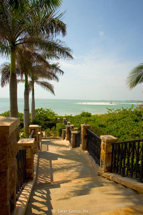 The stairs leading down to the pool with views of the beach.